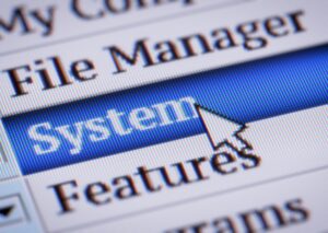 Menu on computer showing options including File Manager, System and Features, with System selected with a mouse pointer.