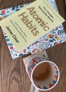 Picture of book Atomic Habits on desk with cup of tea and my ReMARKable